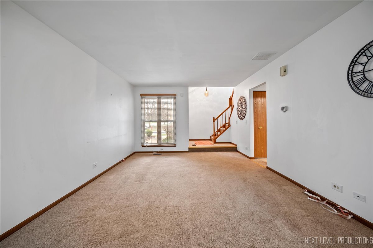 1166 Coldspring Road Elgin, IL 60120 - Photo 4 of 28 an empty room with windows