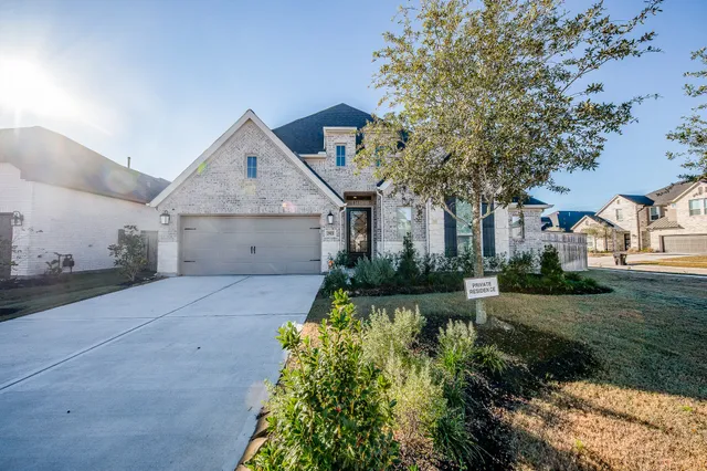 a view of a house with a yard and potted plants