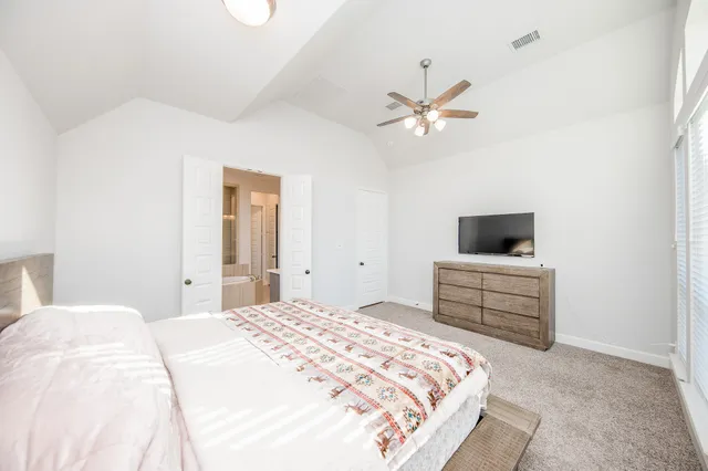 a bedroom with a bed and a television