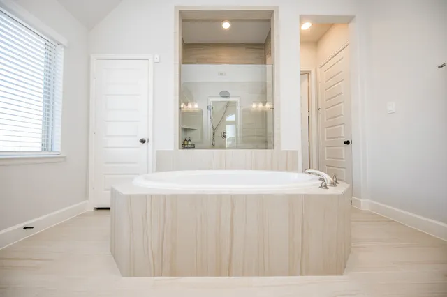 a spacious bathroom with a bathtub and a sink