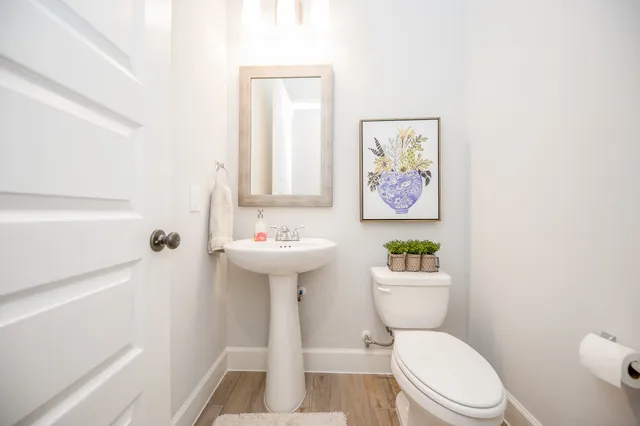 a white toilet sitting next to a bathroom sink