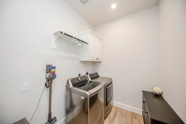 a kitchen with cabinets a sink and wooden floor