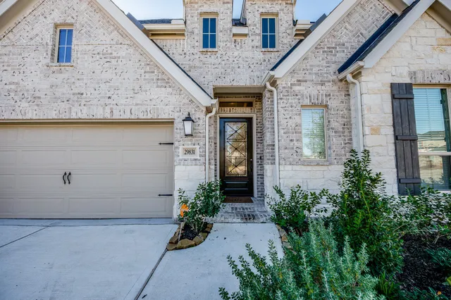 a front view of a house with potted plants