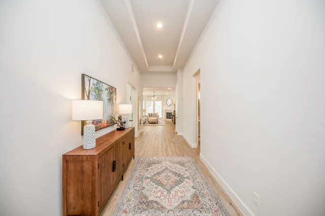 a view of a hallway with furniture