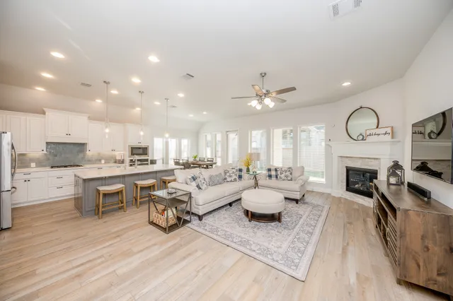 a very nice looking living room with a fireplace and a large window