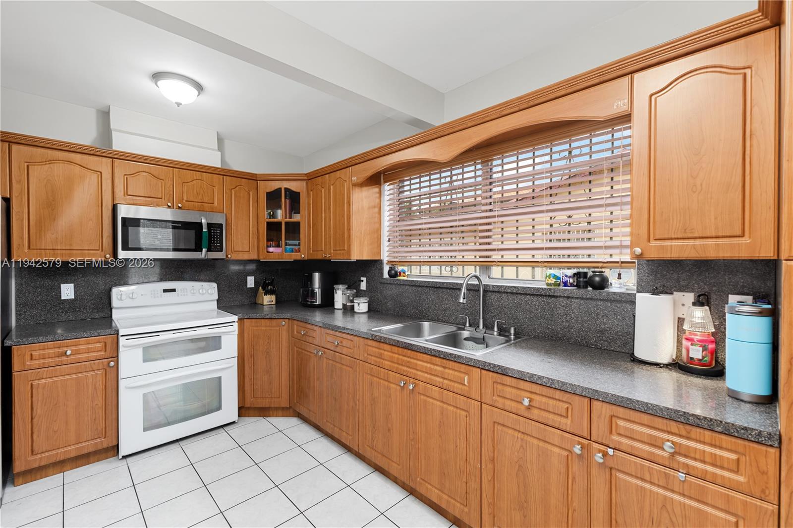 2818 Southwest 2nd Street Miami, FL 33135 - Photo 12 of 47 a kitchen with a sink cabinets and window