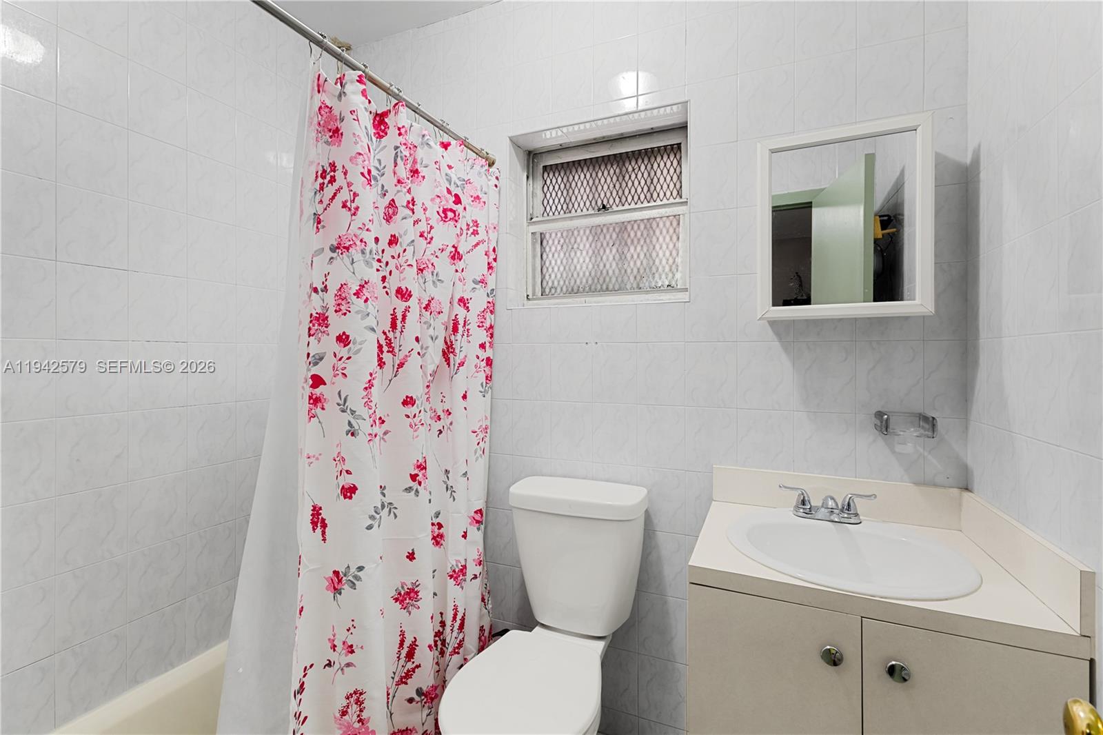 2818 Southwest 2nd Street Miami, FL 33135 - Photo 21 of 47 a white toilet sitting next to a bathroom sink and vanity