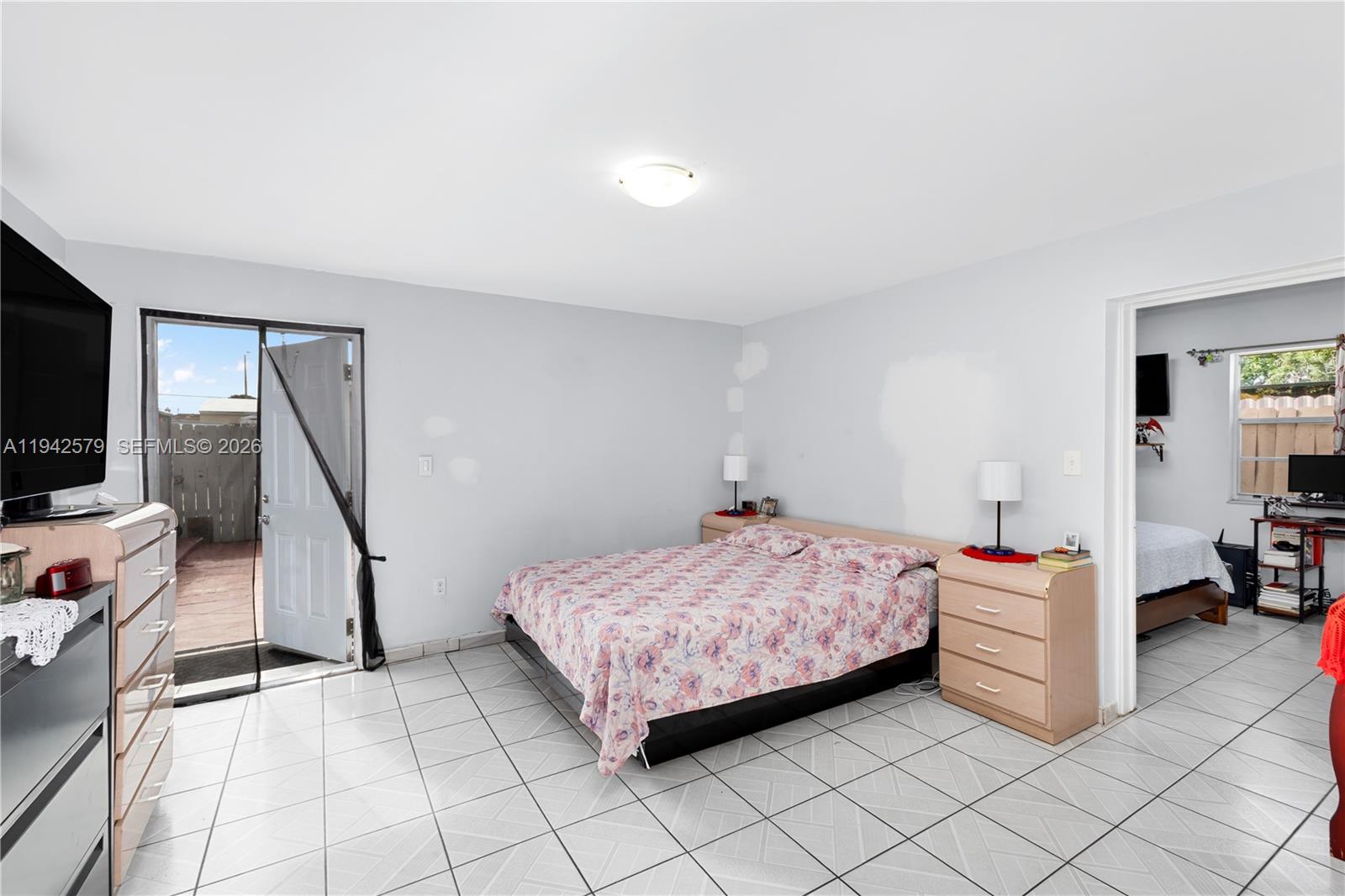 2818 Southwest 2nd Street Miami, FL 33135 - Photo 28 of 47 a bedroom with a bed and a flat screen tv