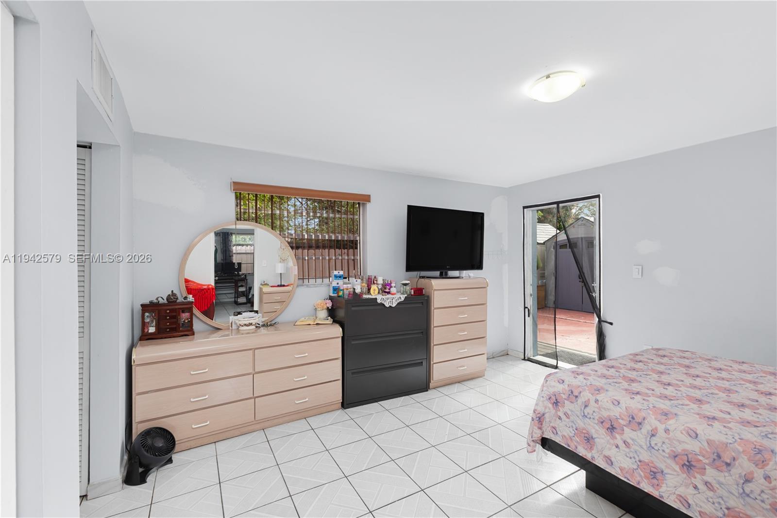 2818 Southwest 2nd Street Miami, FL 33135 - Photo 29 of 47 a bedroom with a bed and a flat screen tv