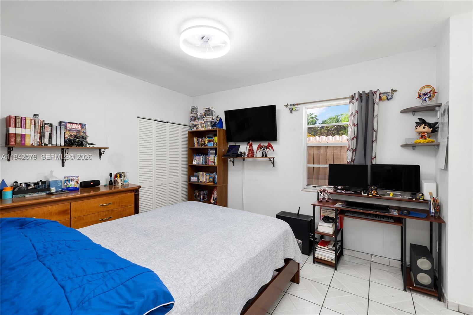 2818 Southwest 2nd Street Miami, FL 33135 - Photo 30 of 47 a bedroom with a bed and a flat screen tv