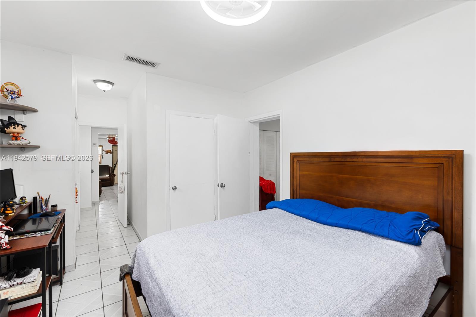 2818 Southwest 2nd Street Miami, FL 33135 - Photo 32 of 47 a bedroom with a bed and a table