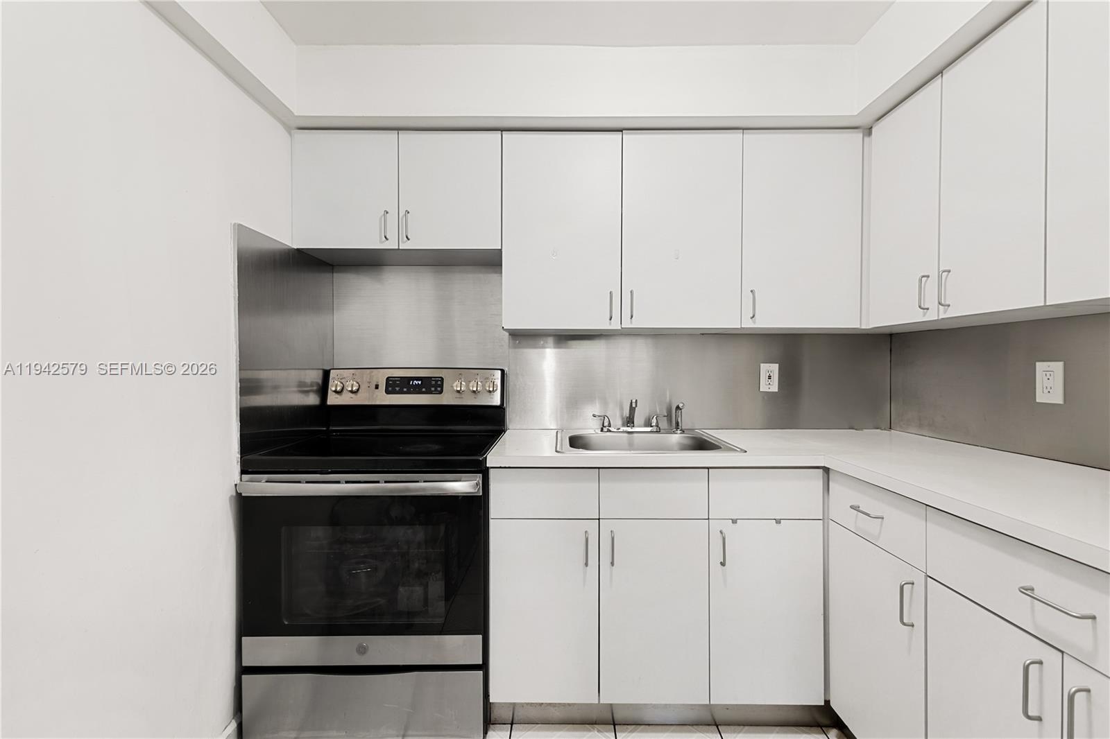 2818 Southwest 2nd Street Miami, FL 33135 - Photo 33 of 47 a kitchen with white cabinets and appliances