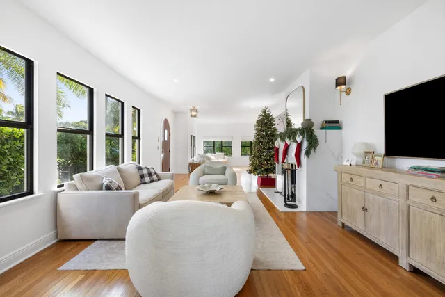 a living room with furniture fireplace and window