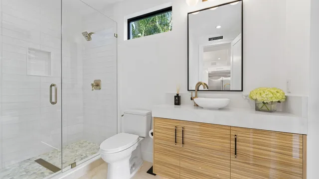 a bedroom with a large bed and a flat tv screen on dresser