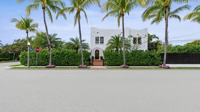 a view of a house with pool and sitting area