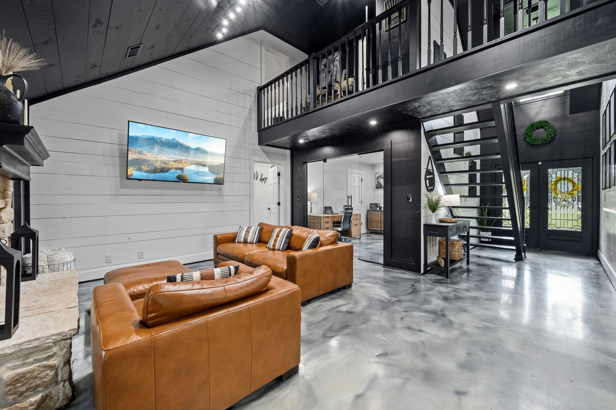18 East Old Field Road Huffman, TX 77336 - Photo 4 of 35 Another captivating perspective of the grand family room highlighting the stunning vertical scale, wood walls, & the sleek floating staircase that serves as a architectural centerpiece leading to the open cat-walk overlook.