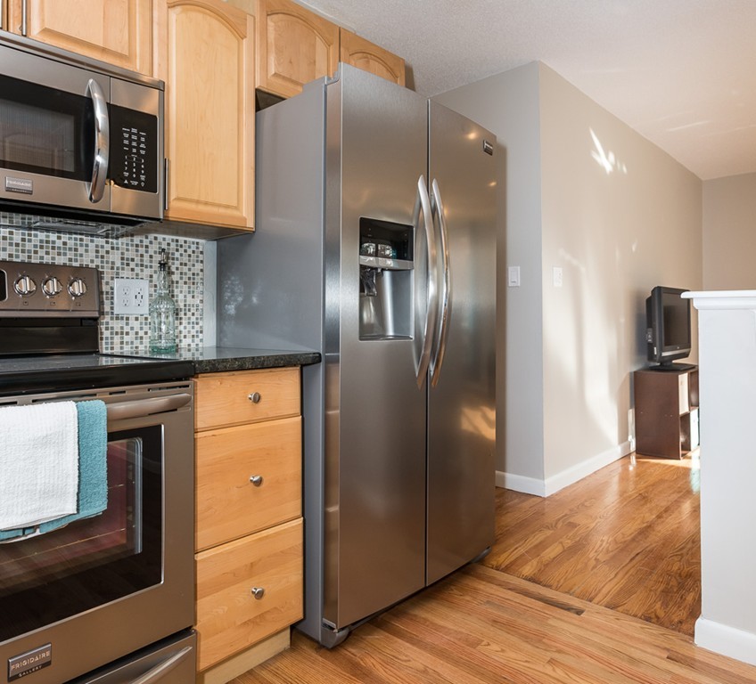54 Ellendale Circle Springfield, MA 01128 - Photo 14 of 27 a kitchen with stainless steel appliances granite countertop a refrigerator and a stove top oven