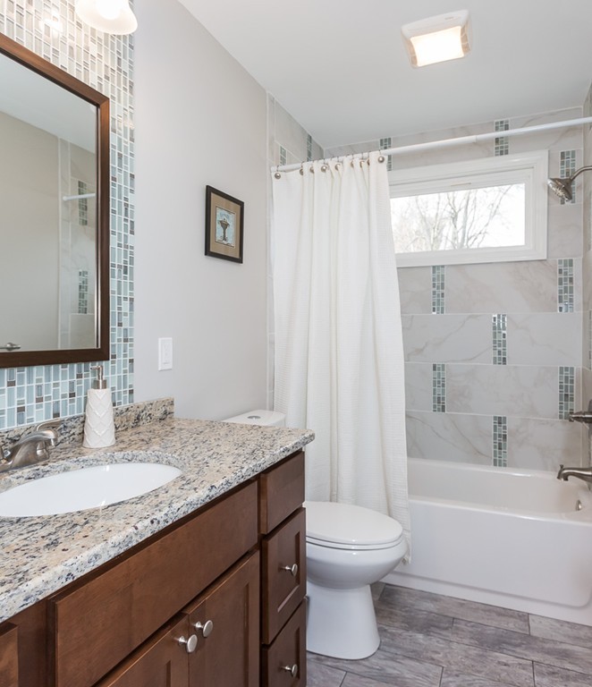 54 Ellendale Circle Springfield, MA 01128 - Photo 18 of 27 a bathroom with a granite countertop sink toilet and shower