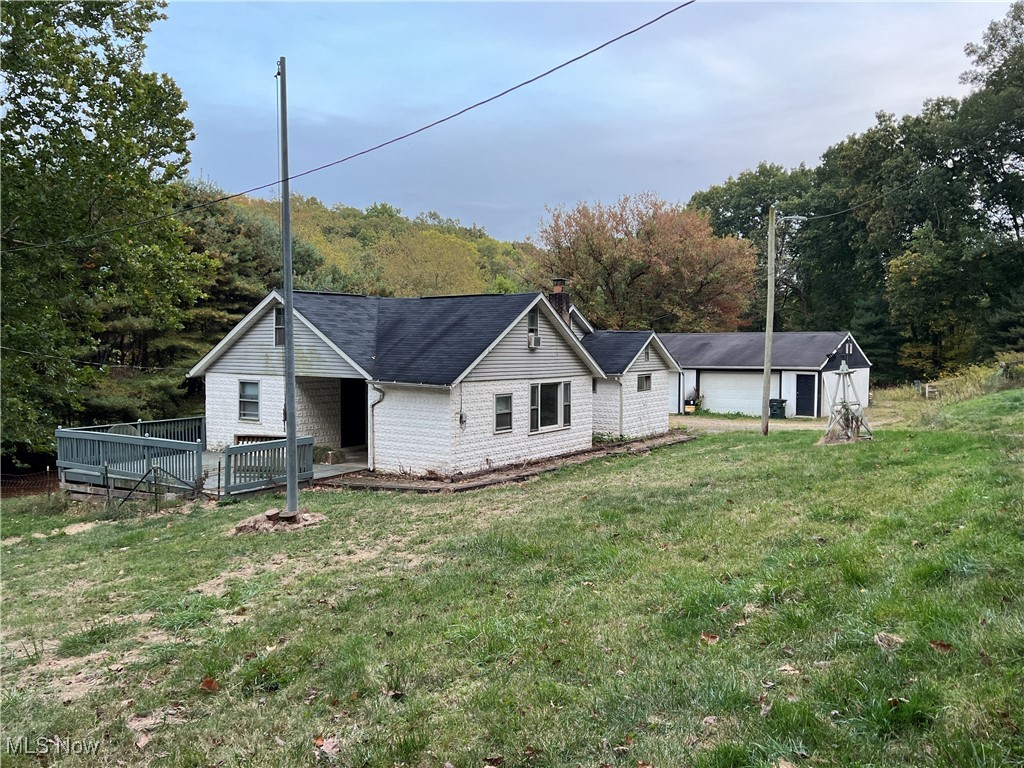 280 Holly Road Northwest Dellroy, OH 44620 - Photo 1 of 26 Back of house featuring a lawn and a garage