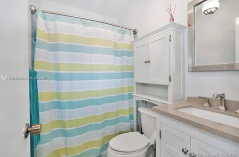 a bathroom with a sink and a shower curtain