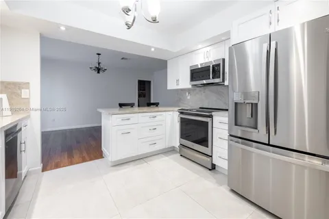 a kitchen with stainless steel appliances a stove a refrigerator and a microwave