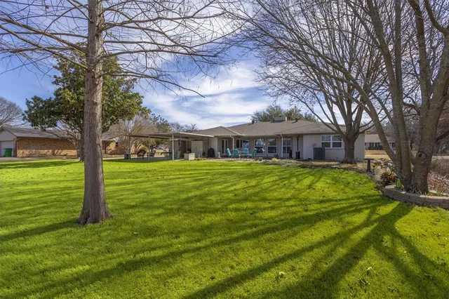 a front view of house with yard and green space
