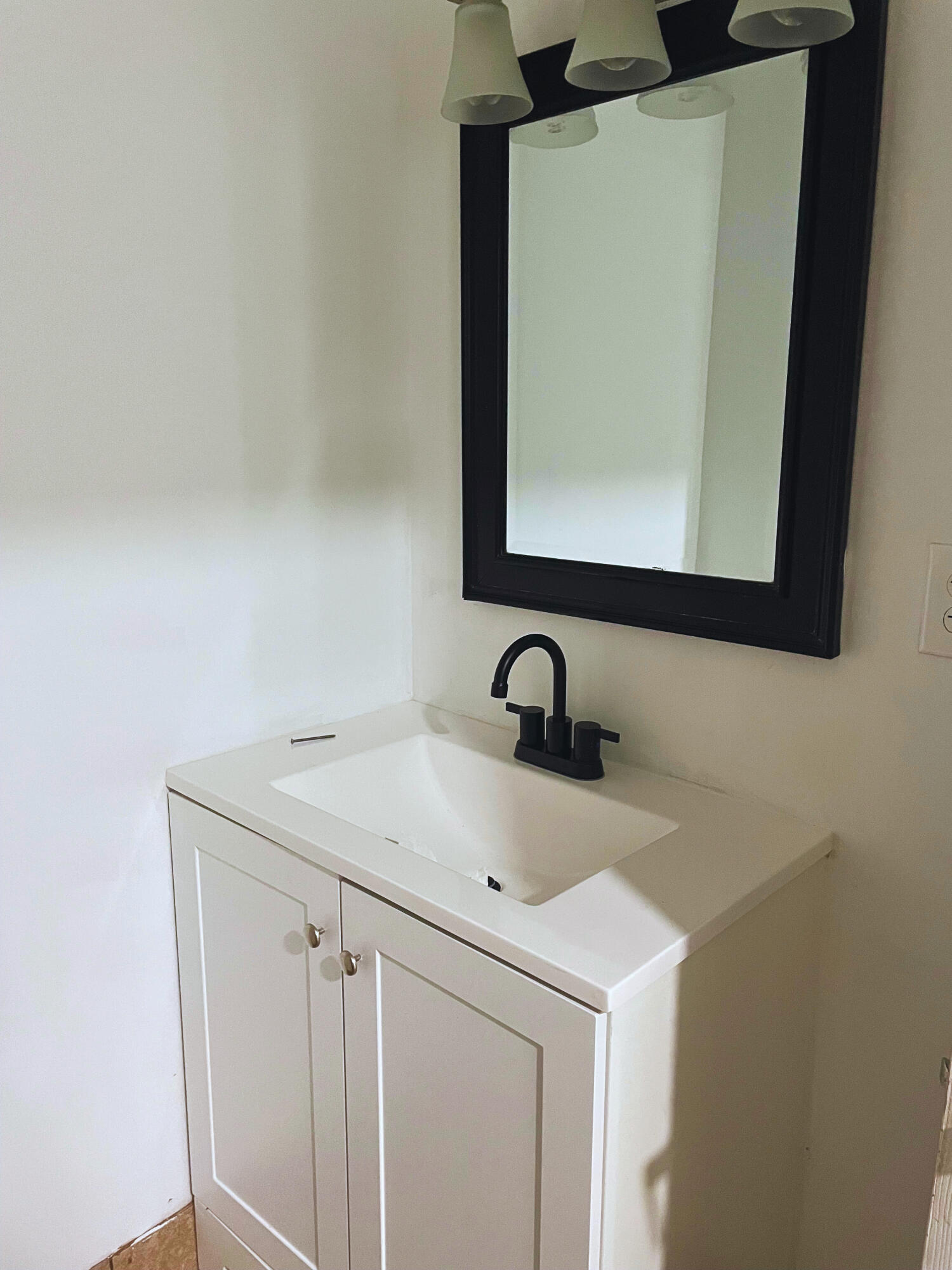 1340 West 33rd Street Riviera Beach, FL 33404 - Photo 14 of 18 a bathroom with a sink and a mirror