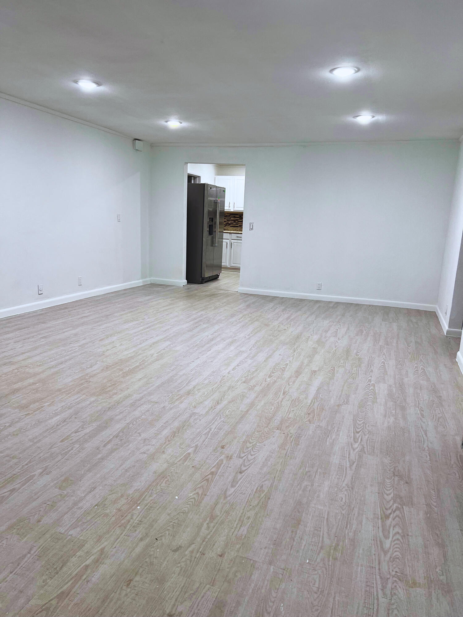 1340 West 33rd Street Riviera Beach, FL 33404 - Photo 4 of 18 a view of an empty room with wooden floor