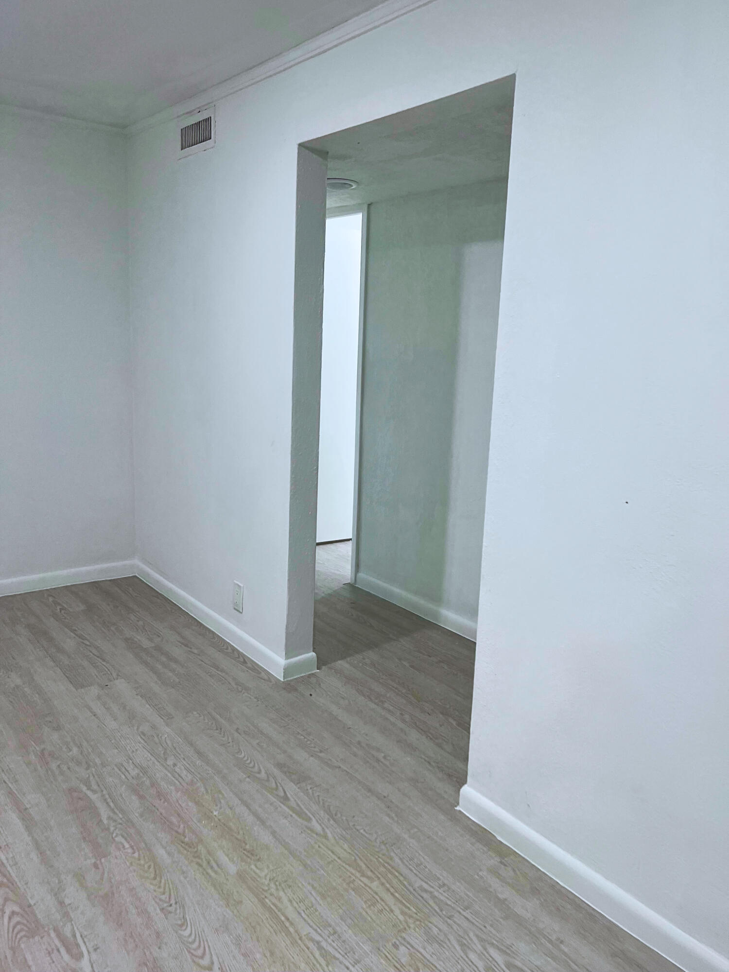 1340 West 33rd Street Riviera Beach, FL 33404 - Photo 7 of 18 a view of a small space with wooden floor and a window