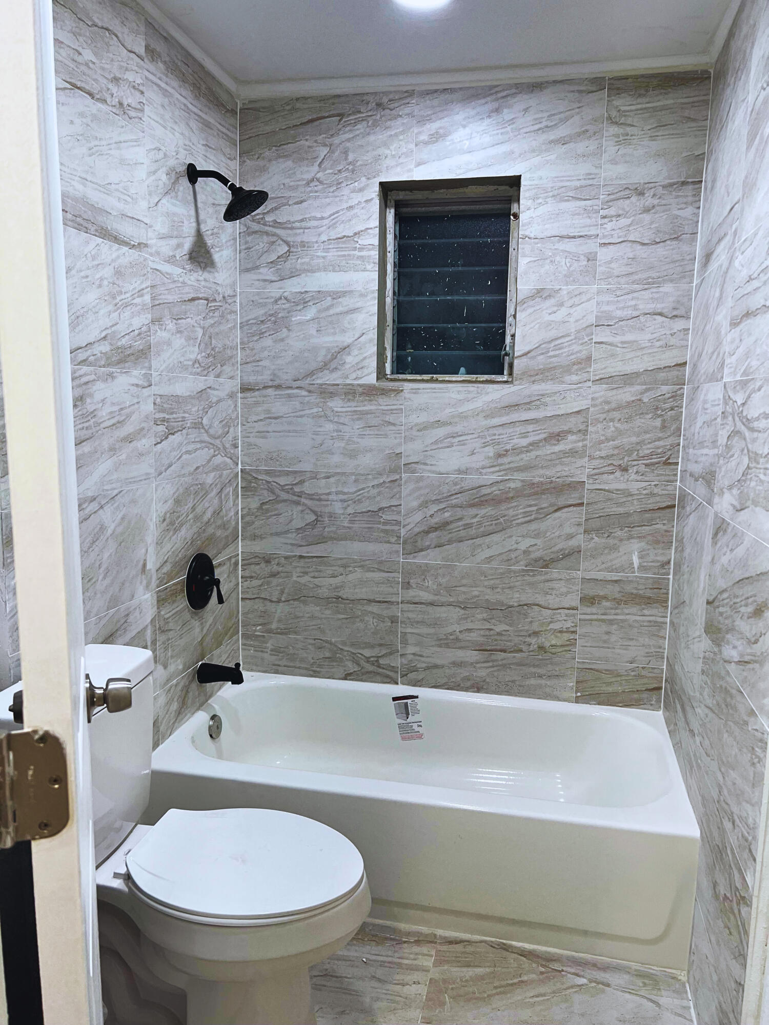 1340 West 33rd Street Riviera Beach, FL 33404 - Photo 8 of 18 a bathroom with a toilet and a bathtub