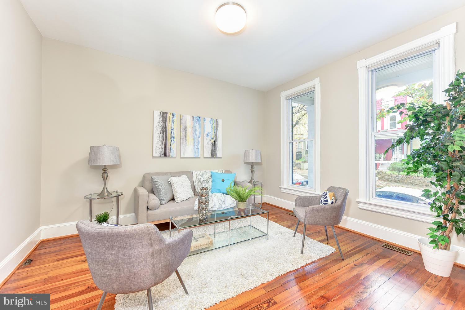 610 Columbia Road Northwest Washington, DC 20001 - Photo 3 of 29 a living room with furniture and a potted plant
