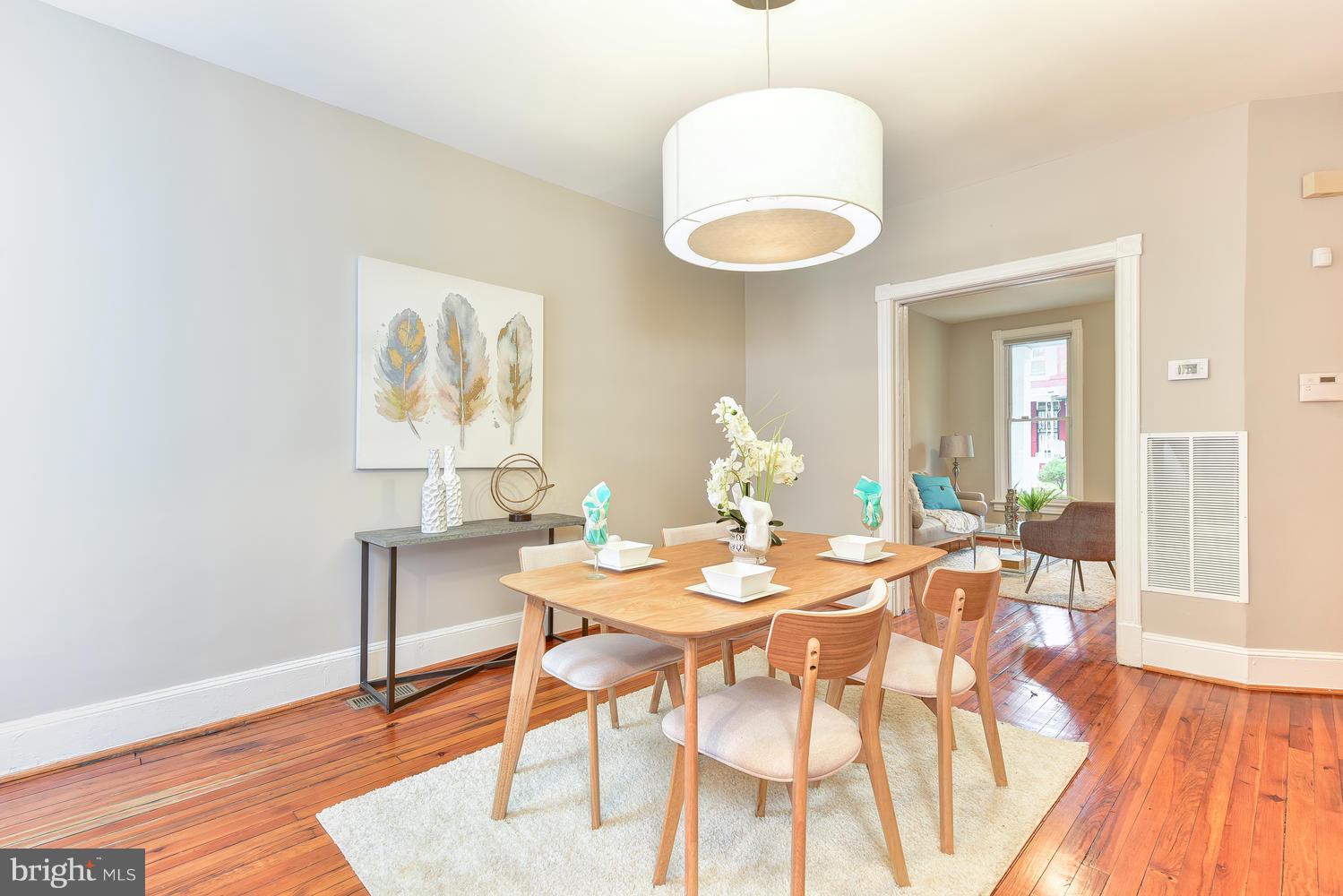 610 Columbia Road Northwest Washington, DC 20001 - Photo 5 of 29 a view of a dining room with furniture and wooden floor
