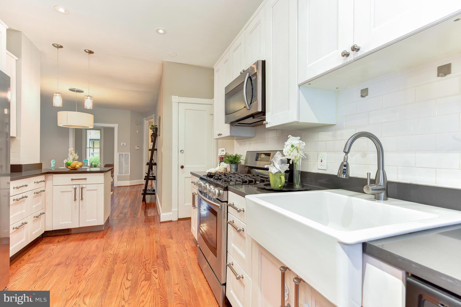 610 Columbia Road Northwest Washington, DC 20001 - Photo 10 of 29 a kitchen with stainless steel appliances a sink stove and cabinets