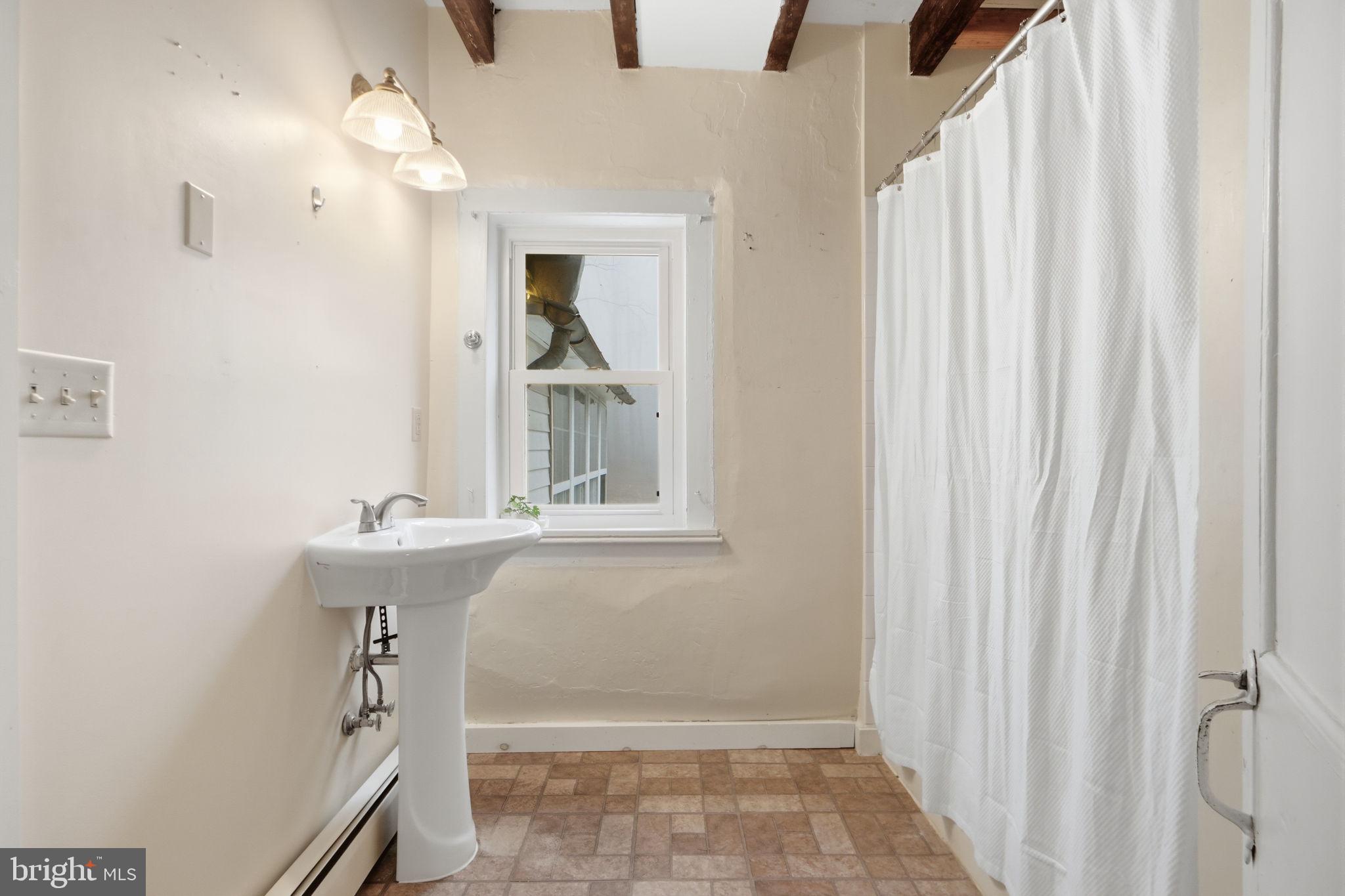7456 Eylers Valley Flint Road Thurmont, MD 21788 - Photo 27 of 51 a bathroom with a sink a mirror and a shower