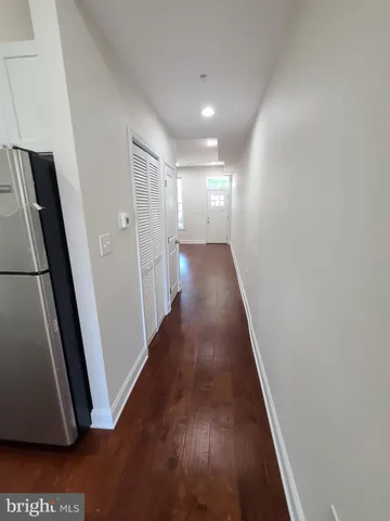a view of a hallway with wooden floor