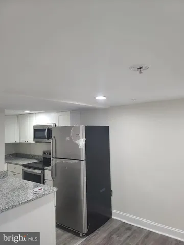 a kitchen with a refrigerator and a sink