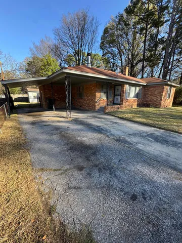 a front view of a house with a yard and a garage