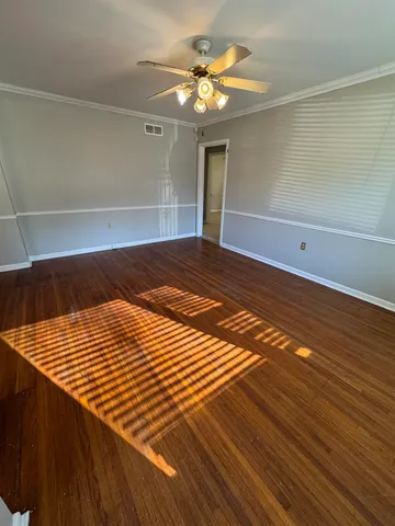 a view of a room with wooden floor