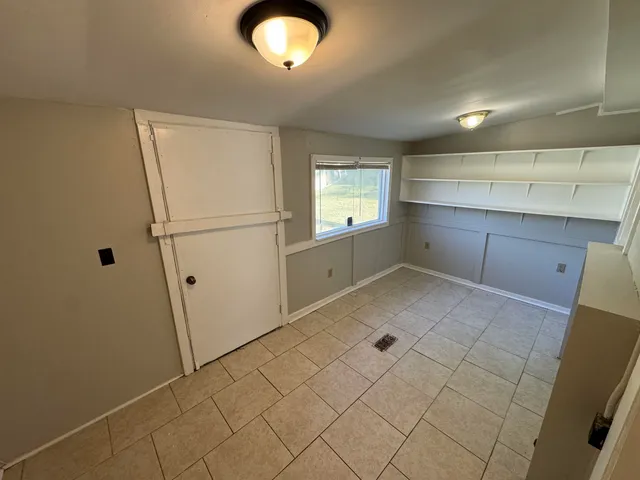 a view of kitchen with refrigerator and window