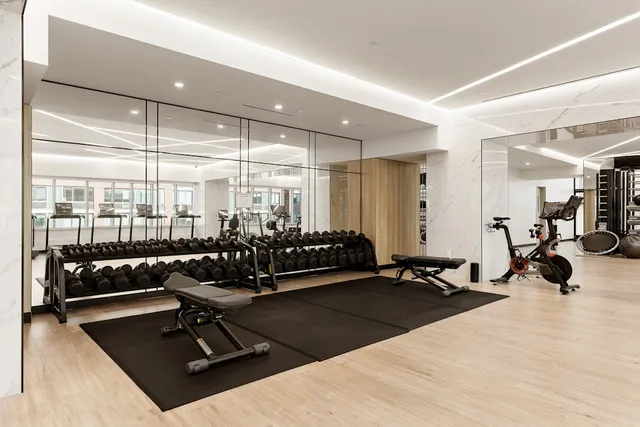a room with gym equipment and a large window