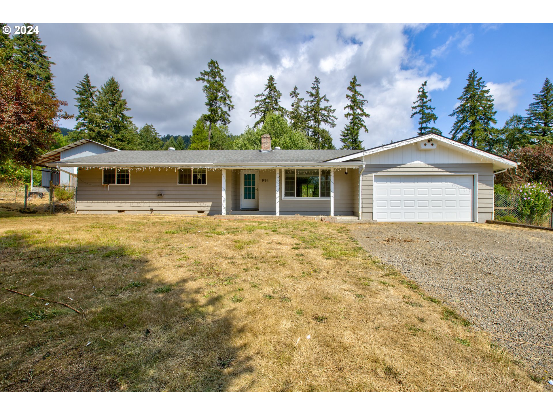 991 Mathis Hill Road Yoncalla, OR 97499 - Photo 1 of 42 a front view of house with yard and trees in the background