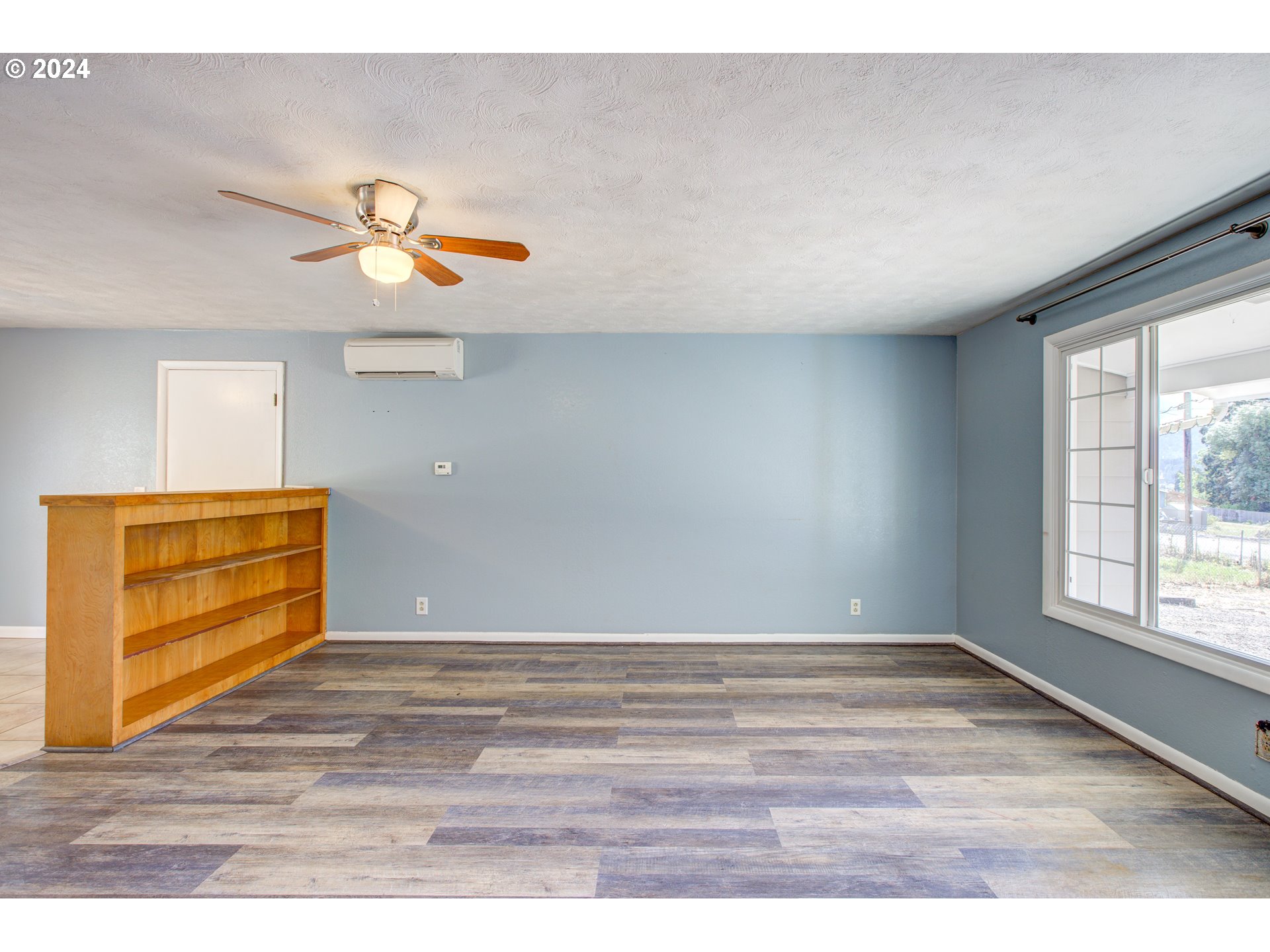 991 Mathis Hill Road Yoncalla, OR 97499 - Photo 5 of 42 a view of a room with wooden floor and window