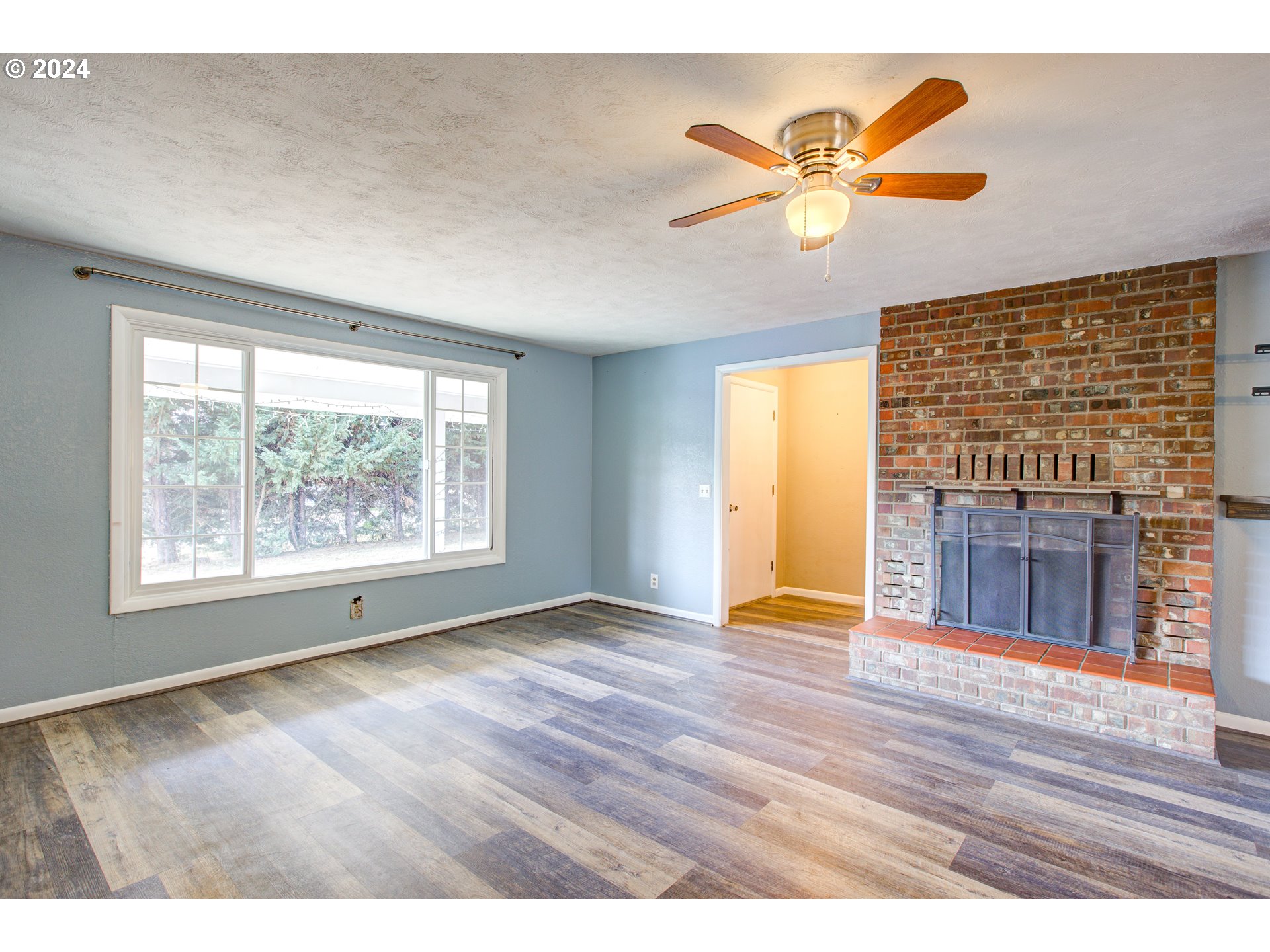 991 Mathis Hill Road Yoncalla, OR 97499 - Photo 7 of 42 a view of an empty room with wooden floor and a window