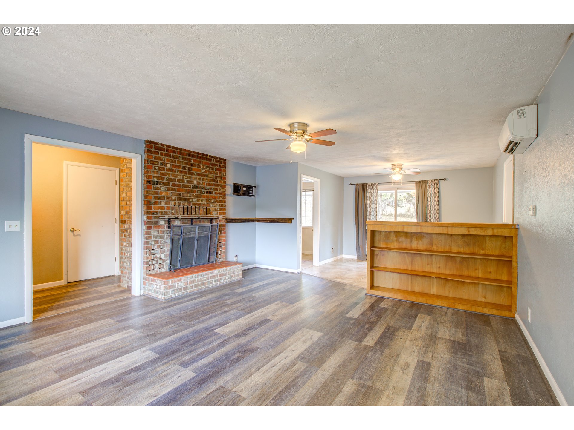 991 Mathis Hill Road Yoncalla, OR 97499 - Photo 8 of 42 a view of empty room with wooden floor and fan