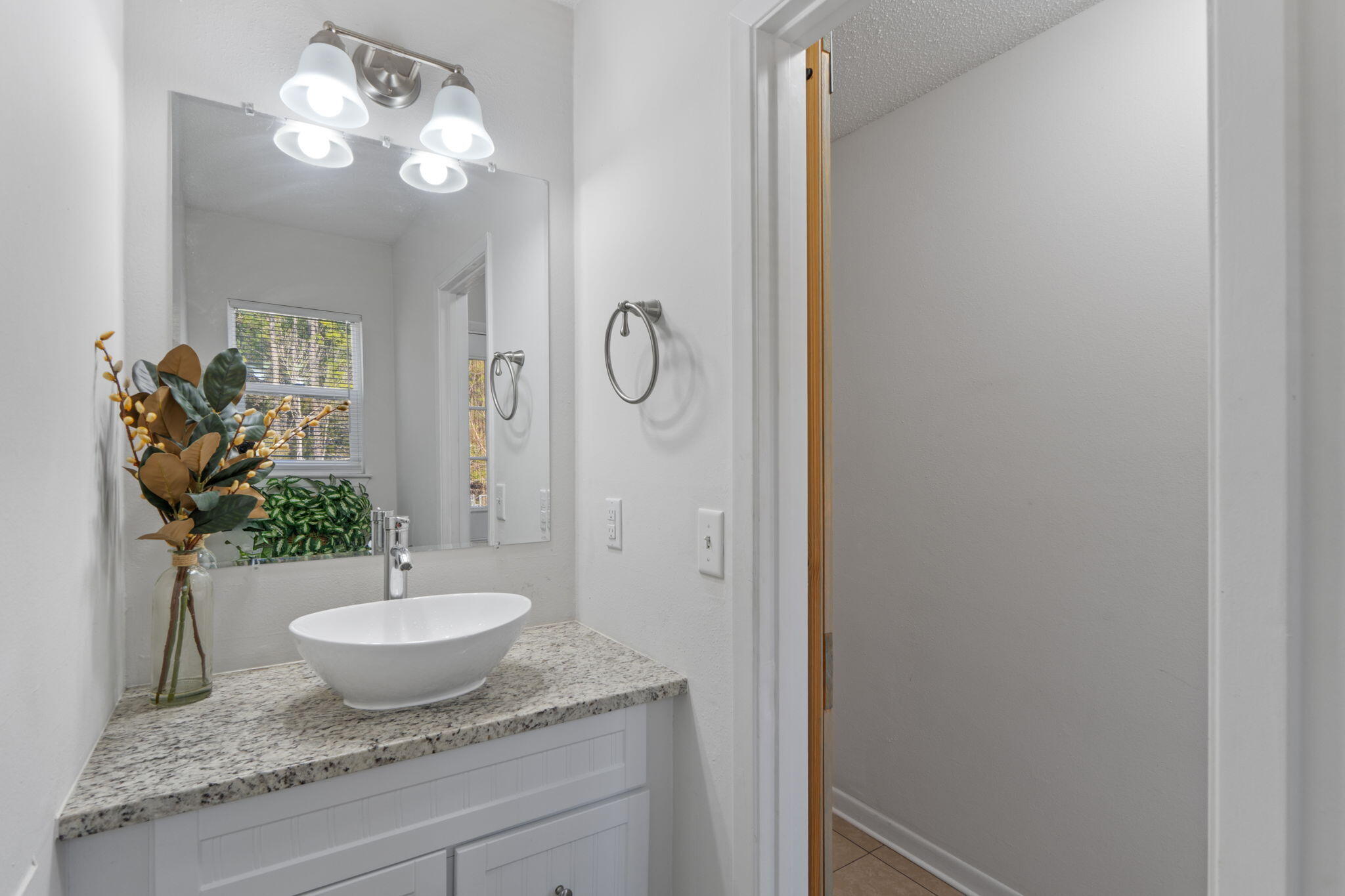 73 Kelly Way Valparaiso, FL 32580 - Photo 13 of 22 a bathroom with a granite countertop sink and a mirror