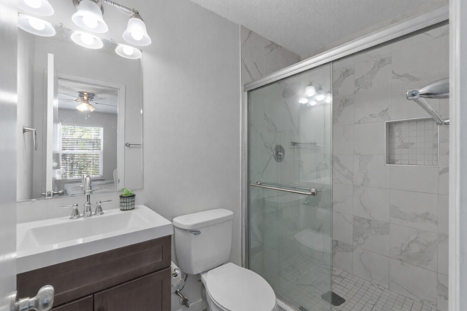 73 Kelly Way Valparaiso, FL 32580 - Photo 16 of 22 a bathroom with a sink toilet a mirror and shower