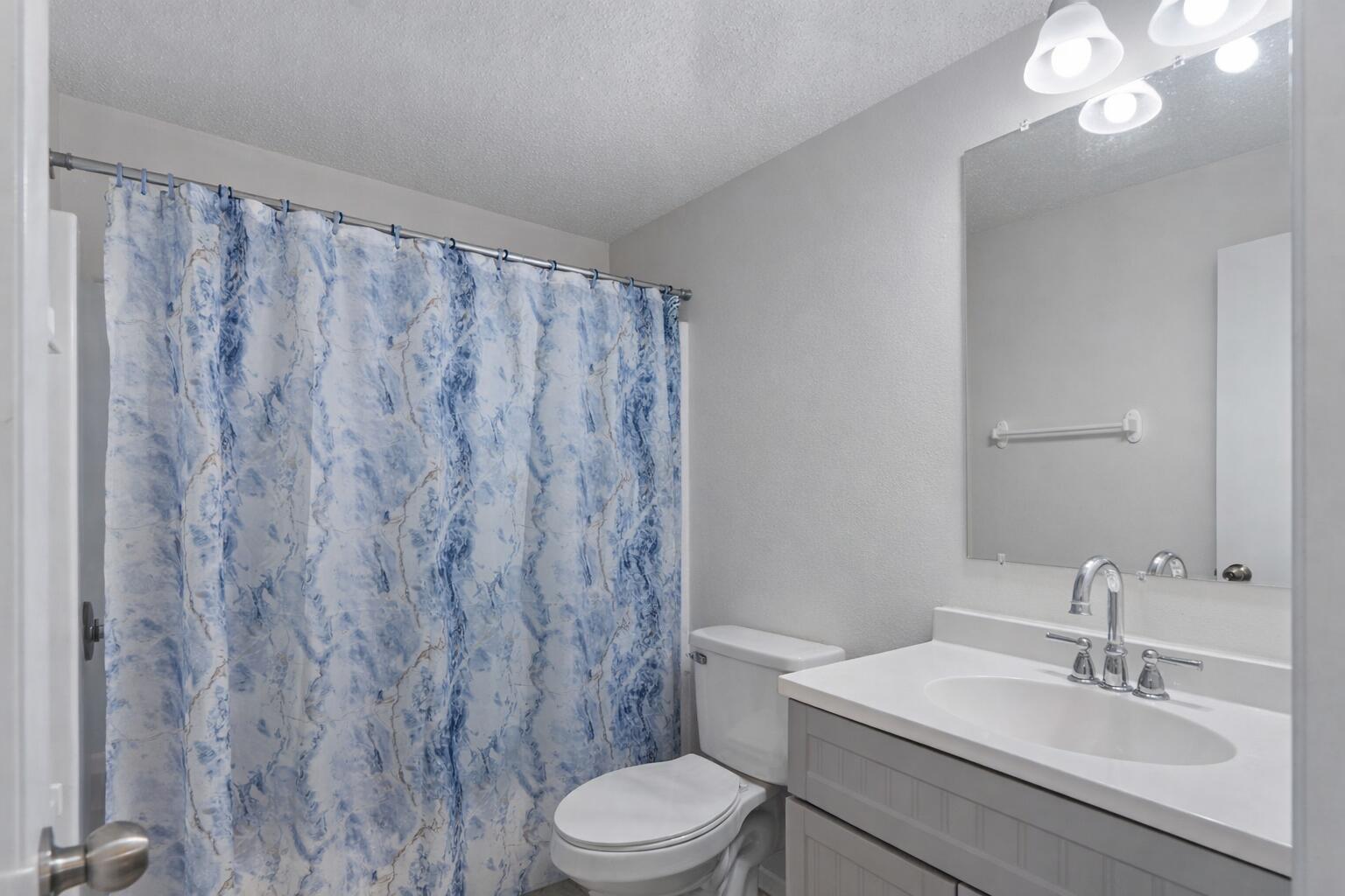 73 Kelly Way Valparaiso, FL 32580 - Photo 19 of 22 a bathroom with a toilet a sink and a mirror