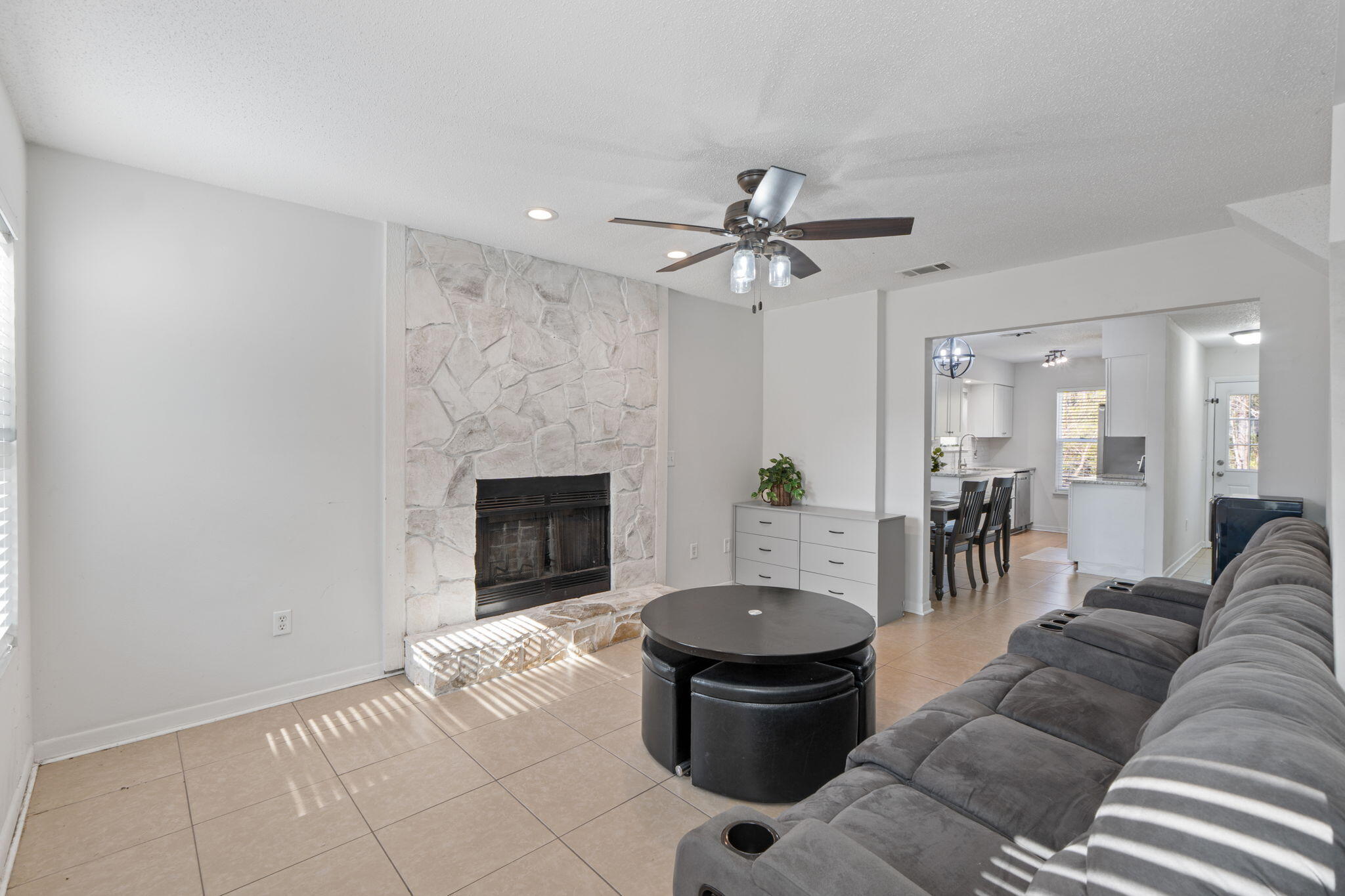 73 Kelly Way Valparaiso, FL 32580 - Photo 2 of 22 a living room with furniture a fireplace and a chandelier