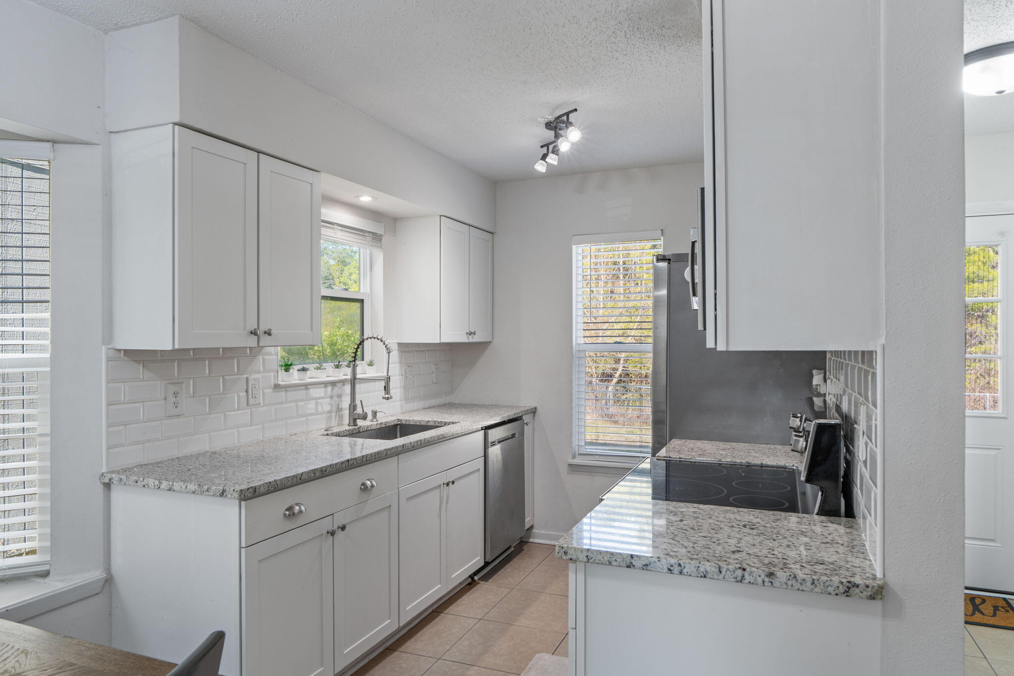 73 Kelly Way Valparaiso, FL 32580 - Photo 7 of 22 a kitchen with granite countertop a sink stainless steel appliances and cabinets