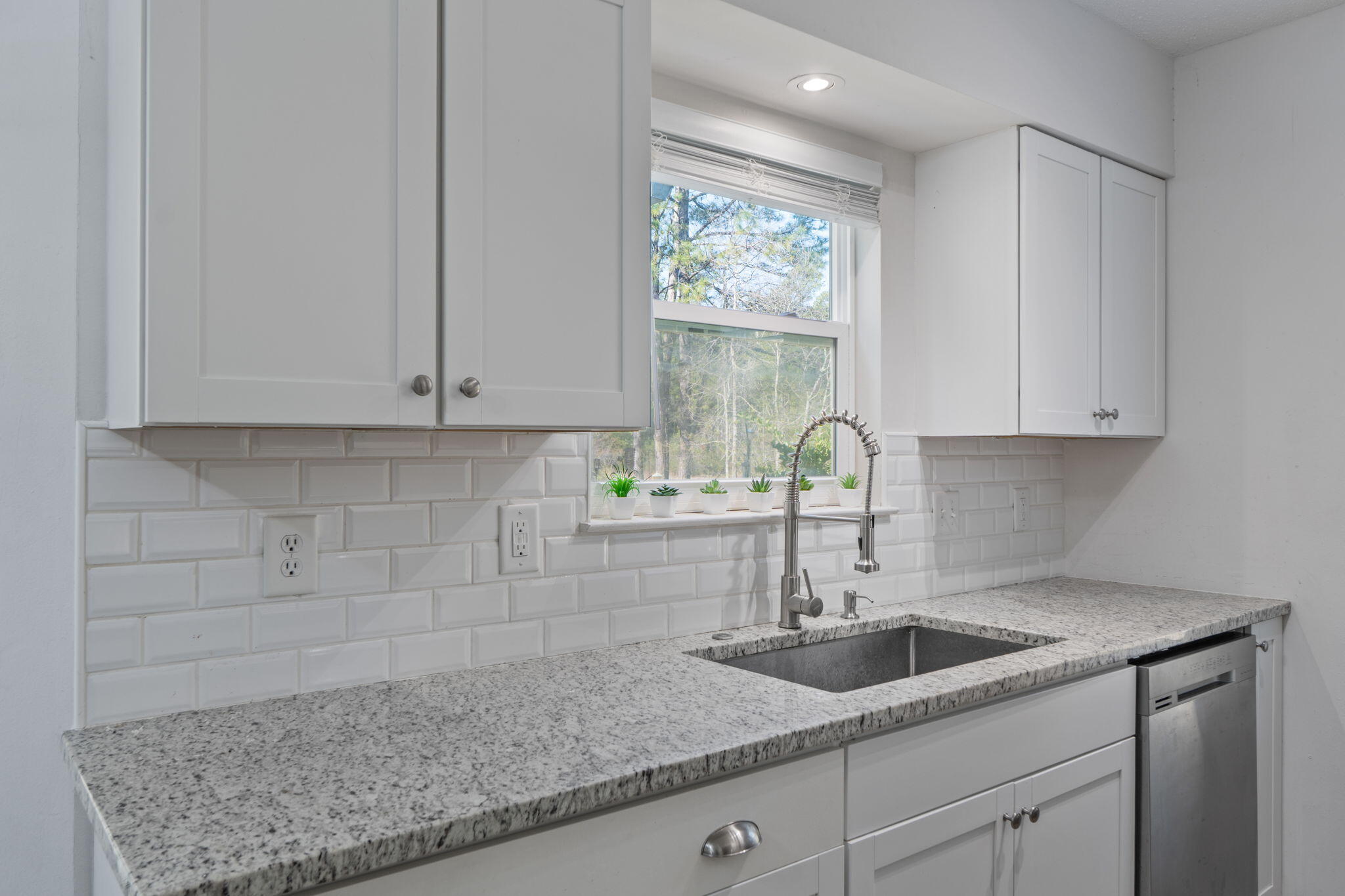 73 Kelly Way Valparaiso, FL 32580 - Photo 9 of 22 a kitchen with granite countertop white cabinets and a sink